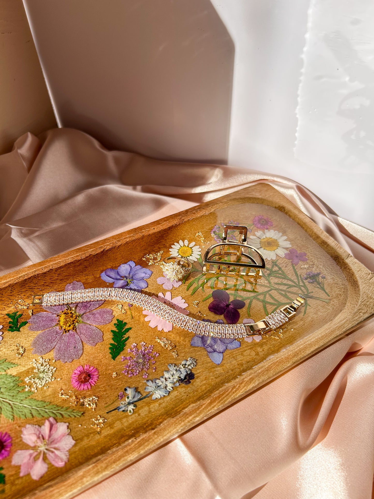 A beautiful decorative wood and resin tray with real natural dried flowers in a colorful pink, purple, green, white, yellow, and blue arrangement. size is 35 cm × 14 cm, approximately 13.78 inches × 5.51 inches. It is a beautiful thoughtful gift for a loved one and decorates every space effortlessly.