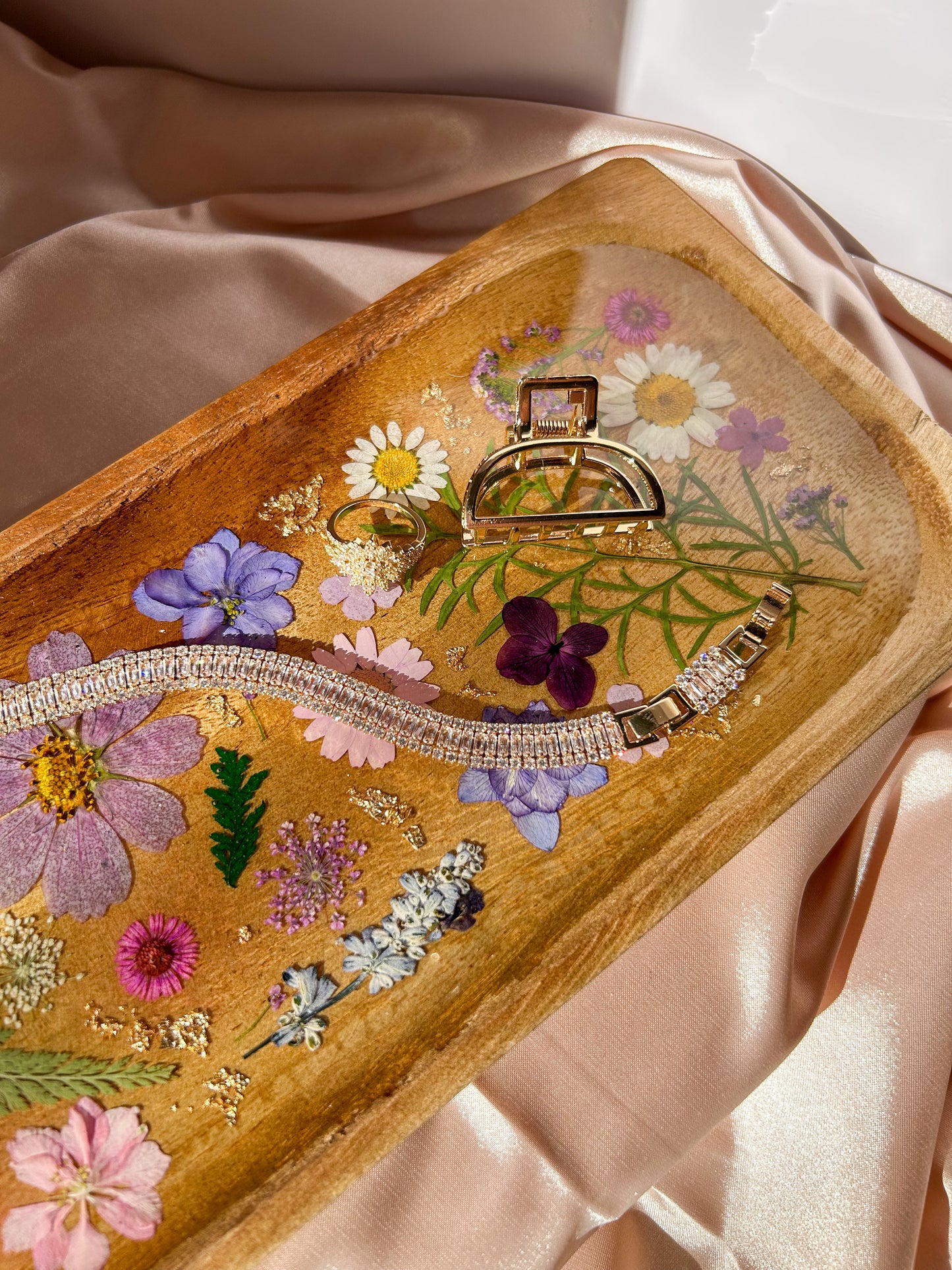 A beautiful decorative wood and resin tray with real natural dried flowers in a colorful pink, purple, green, white, yellow, and blue arrangement. size is 35 cm × 14 cm, approximately 13.78 inches × 5.51 inches. It is a beautiful thoughtful gift for a loved one and decorates every space effortlessly.