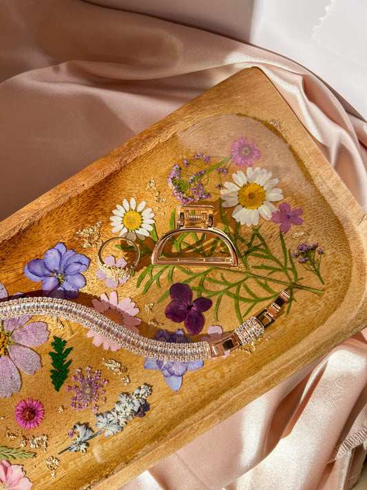 A beautiful decorative wood and resin tray with real natural dried flowers in a colorful pink, purple, green, white, yellow, and blue arrangement. size is 35 cm × 14 cm, approximately 13.78 inches × 5.51 inches. It is a beautiful thoughtful gift for a loved one and decorates every space effortlessly.