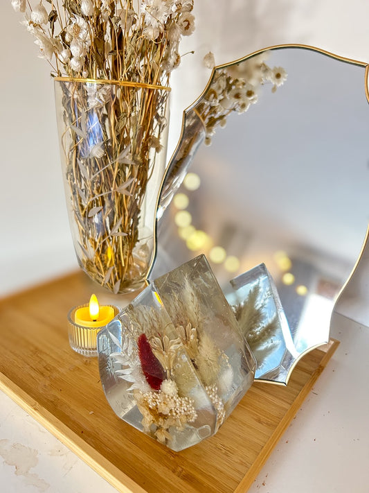 Gem-shaped resin decor featuring a preserved bouquet of dried flowers, including a striking burgundy red flower, all encased in clear resin. Handmade botanical art, perfect for unique home decor or as a thoughtful gift.