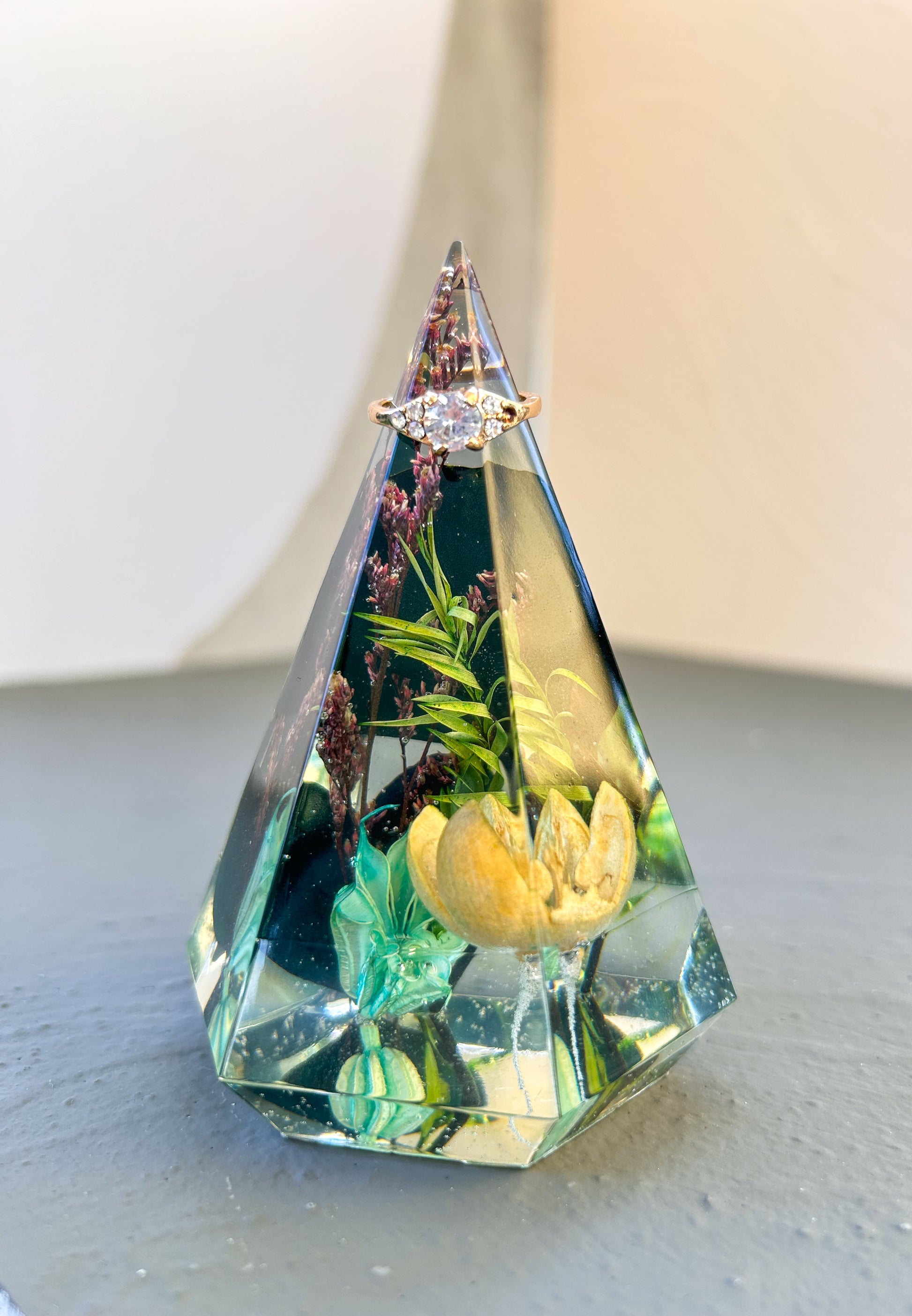 a beautiful handmade resin ring tree ring cone featuring floral dried botanicals. perfect for displaying rings, a unique botanical gift. beautiful vanity, bedroom, bathroom, office, tabletop, nightstand decor. Great as a unique gift for a loved one.