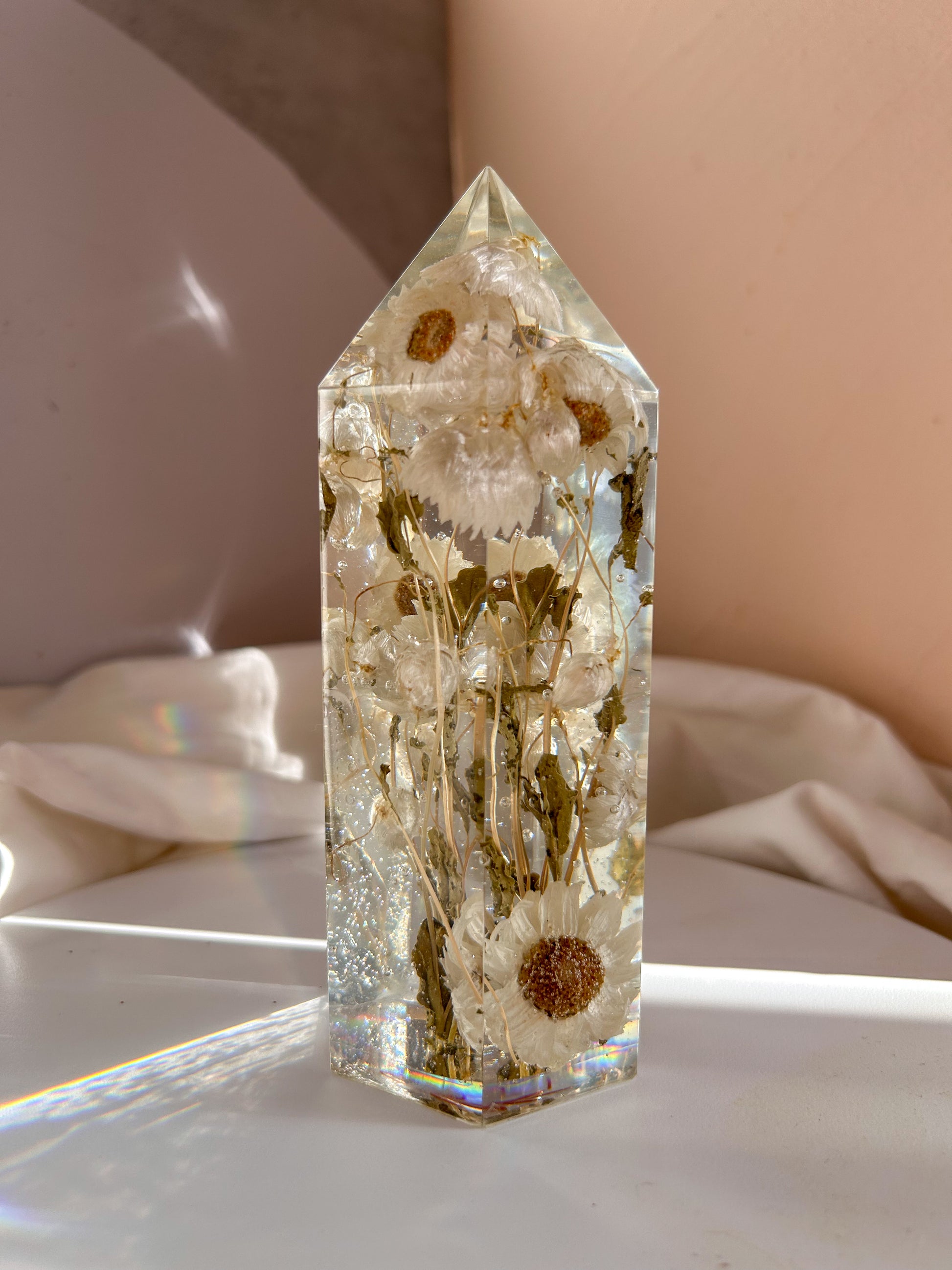 Handmade resin crystal tower featuring a real preserved dried flower daisy, captured in clear resin for a timeless look. Great for home decor, gifts, unique presents, vanity bedroom decor and shelf decor.