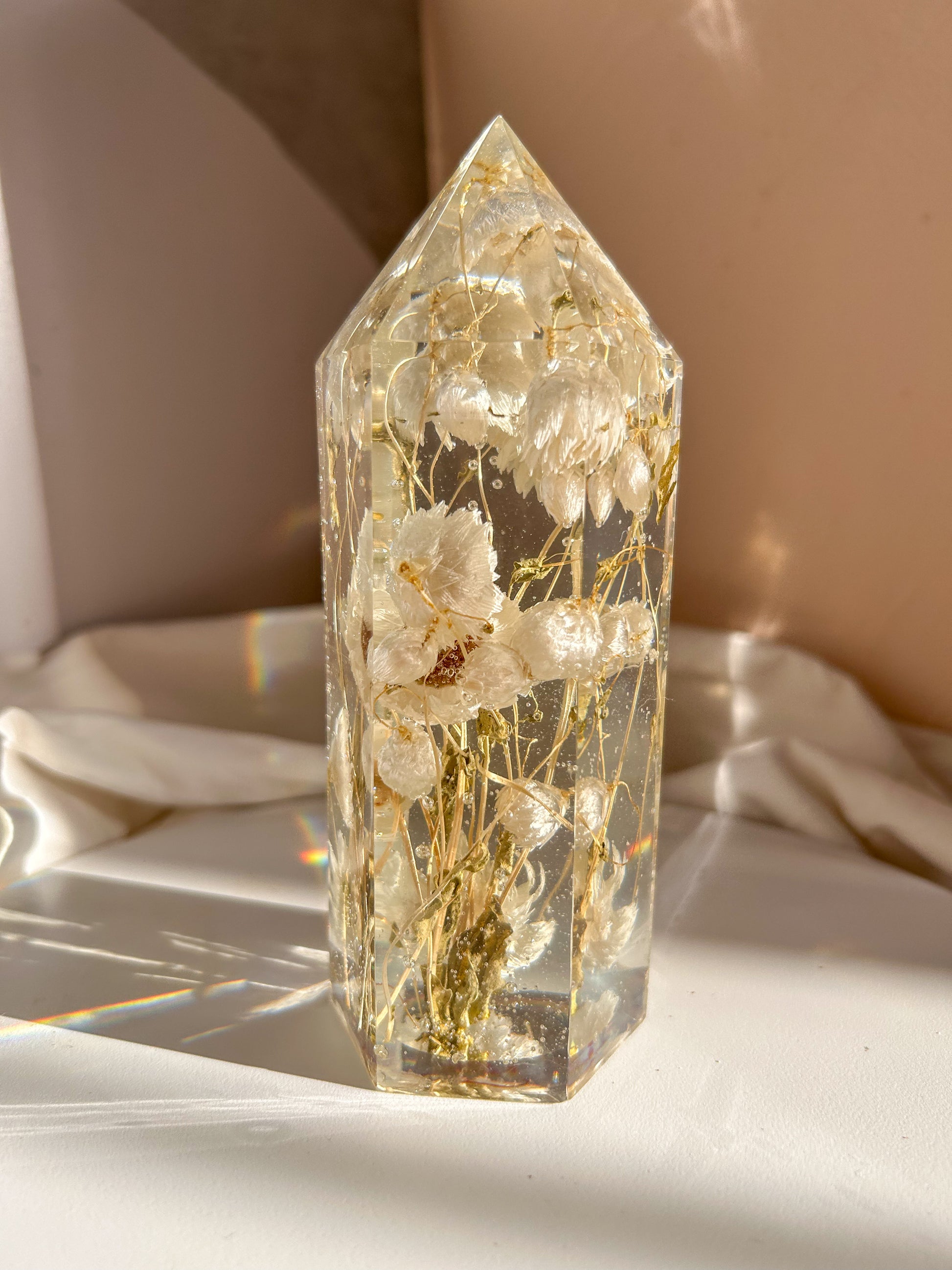 Handmade resin crystal tower featuring a real preserved dried flower daisy, captured in clear resin for a timeless look. Great for home decor, gifts, unique presents, vanity bedroom decor and shelf decor.