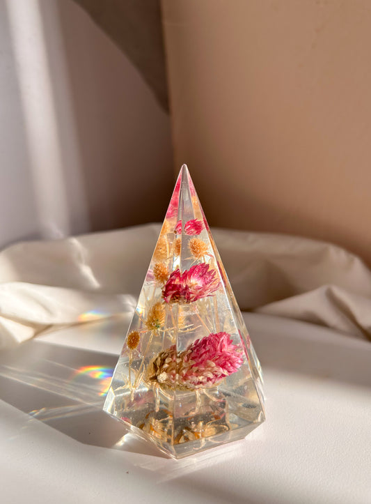 a handmade resin ring tree ring cone featuring floral dried botanicals, a dried desert beige thorn with vibrant fuchsia pink spiky flower. perfect for displaying rings, a unique botanical gift. beautiful, bedroom, bathroom, office, nightstand decor