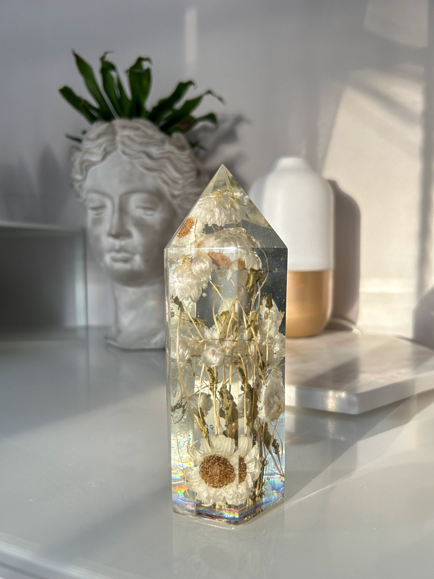 Handmade resin crystal tower featuring a real preserved dried flower daisy, captured in clear resin for a timeless look. Great for home decor, gifts, unique presents, vanity bedroom decor and shelf decor.