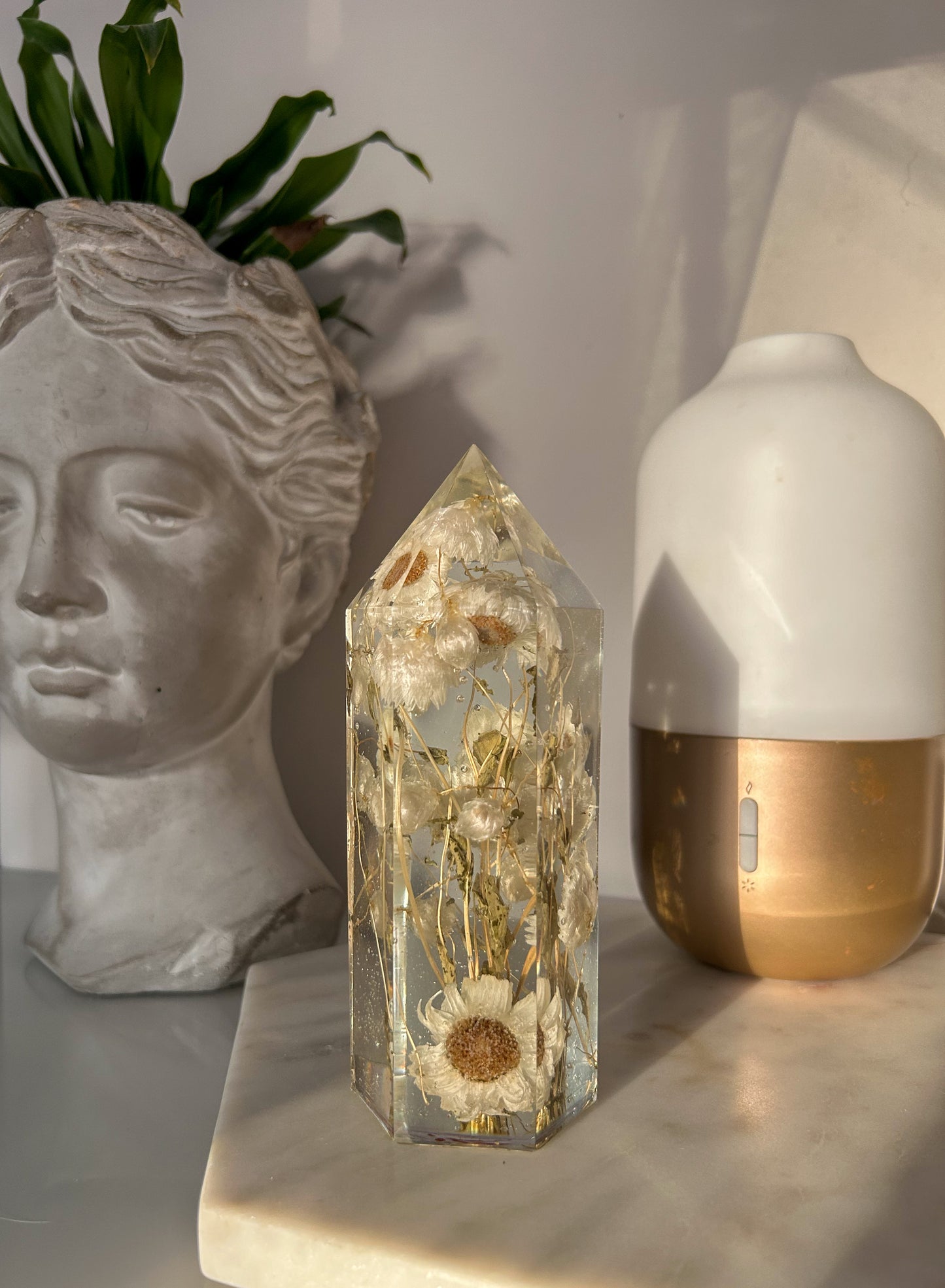 Handmade resin crystal tower featuring a real preserved dried flower daisy, captured in clear resin for a timeless look. Great for home decor, gifts, unique presents, vanity bedroom decor and shelf decor.