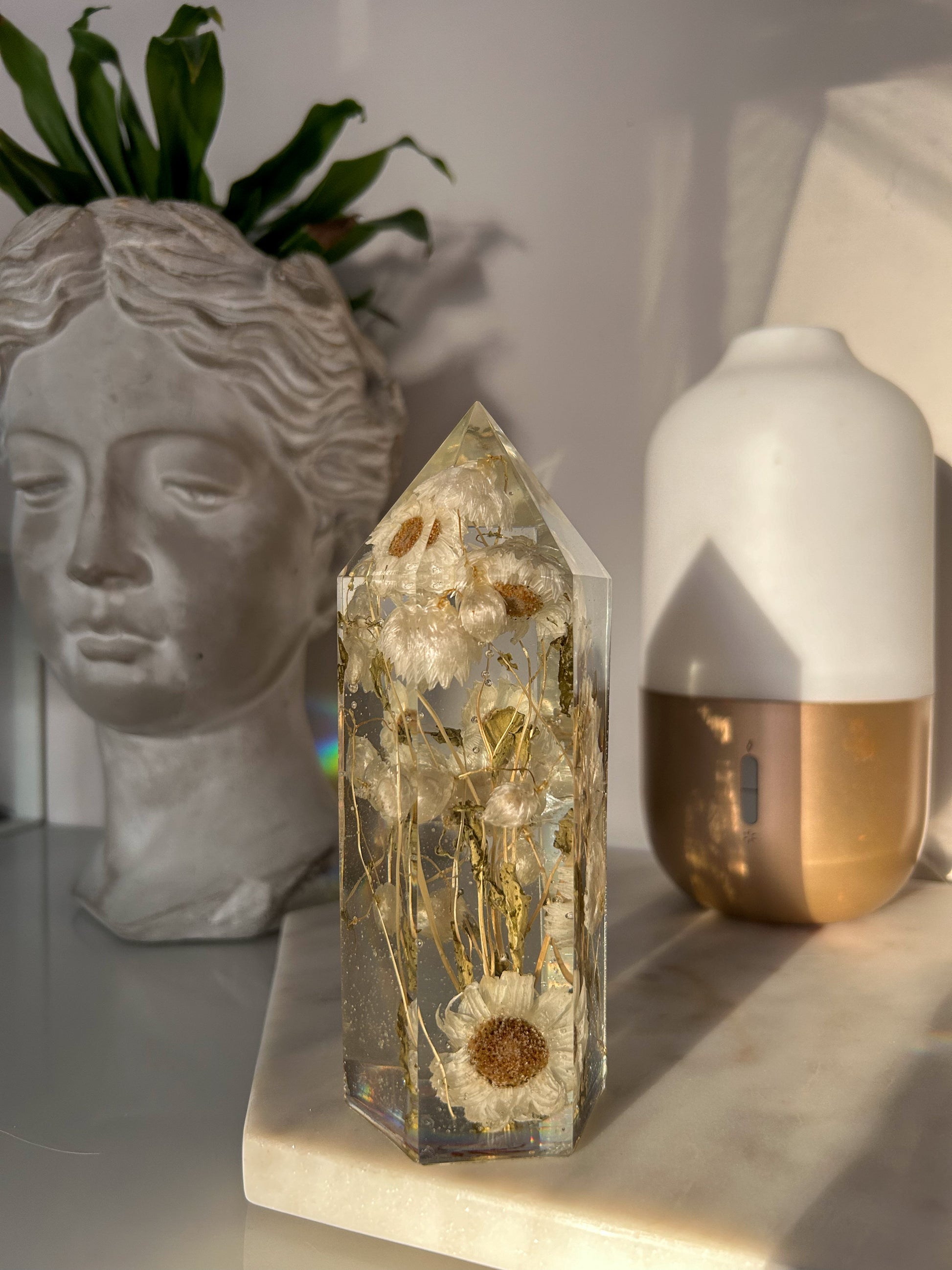 Handmade resin crystal tower featuring a real preserved dried flower daisy, captured in clear resin for a timeless look. Great for home decor, gifts, unique presents, vanity bedroom decor and shelf decor.