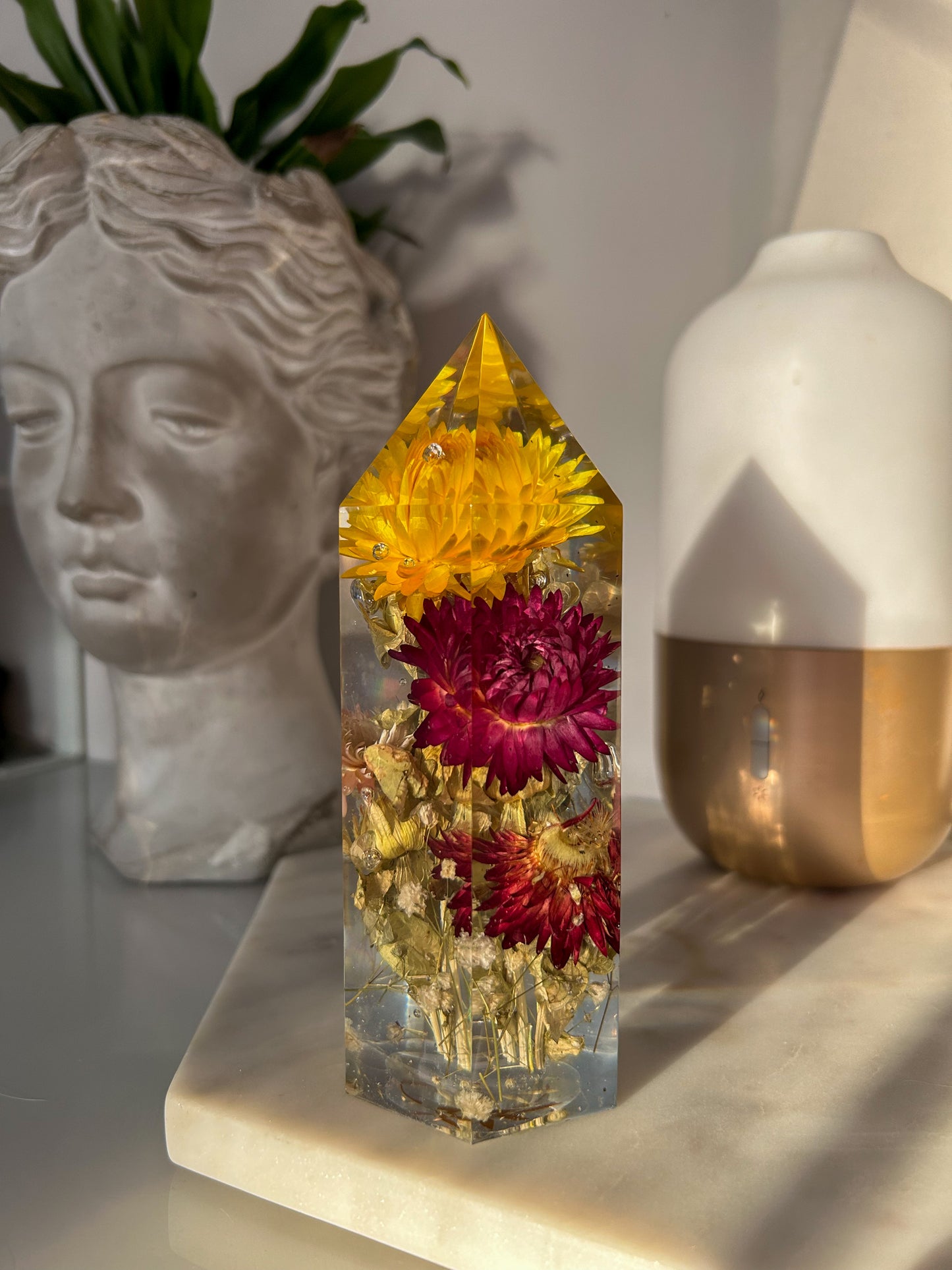 Handmade resin crystal tower featuring a real preserved colorful yellow orange purple pink green flowers, captured in clear resin for a timeless look. Great for home decor, gifts, unique presents, vanity bedroom decor and shelf decor.