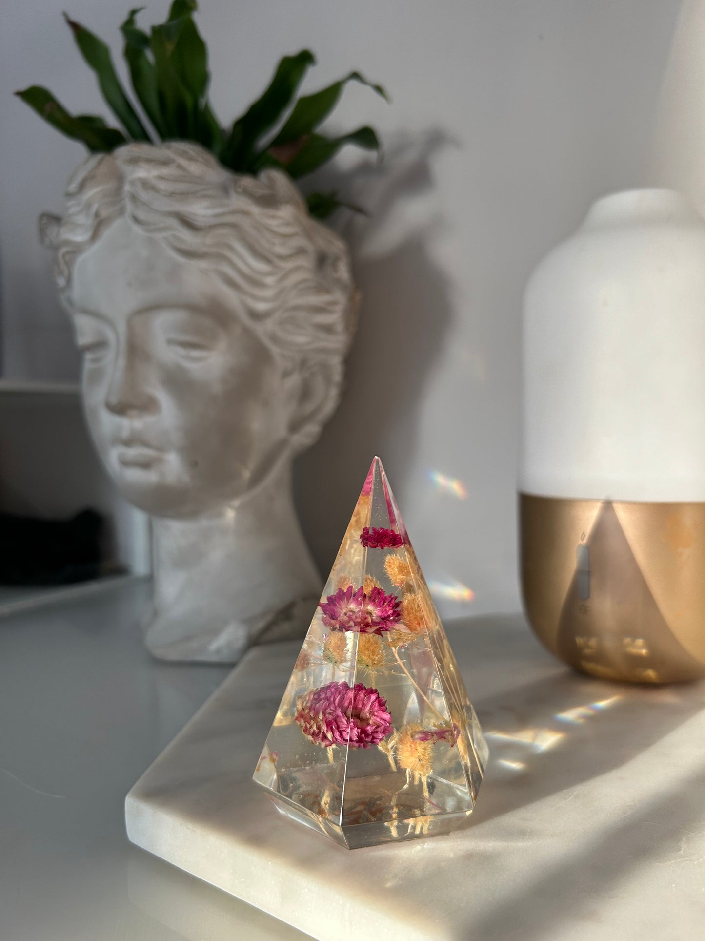 a handmade resin ring tree ring cone featuring floral dried botanicals, a dried desert beige thorn with vibrant fuchsia pink spiky flower. perfect for displaying rings, a unique botanical gift. beautiful, bedroom, bathroom, office, nightstand decor