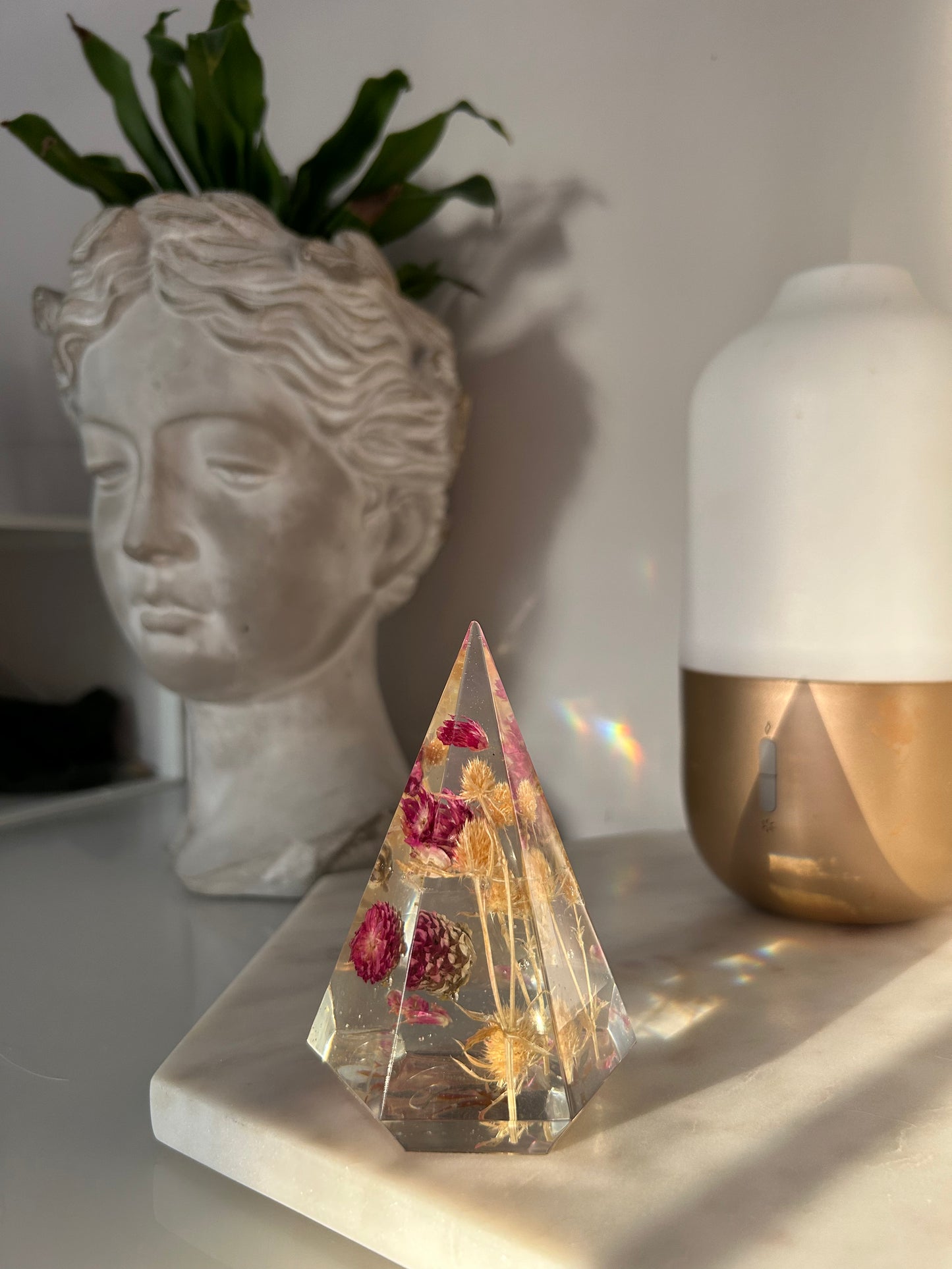 a handmade resin ring tree ring cone featuring floral dried botanicals, a dried desert beige thorn with vibrant fuchsia pink spiky flower. perfect for displaying rings, a unique botanical gift. beautiful, bedroom, bathroom, office, nightstand decor