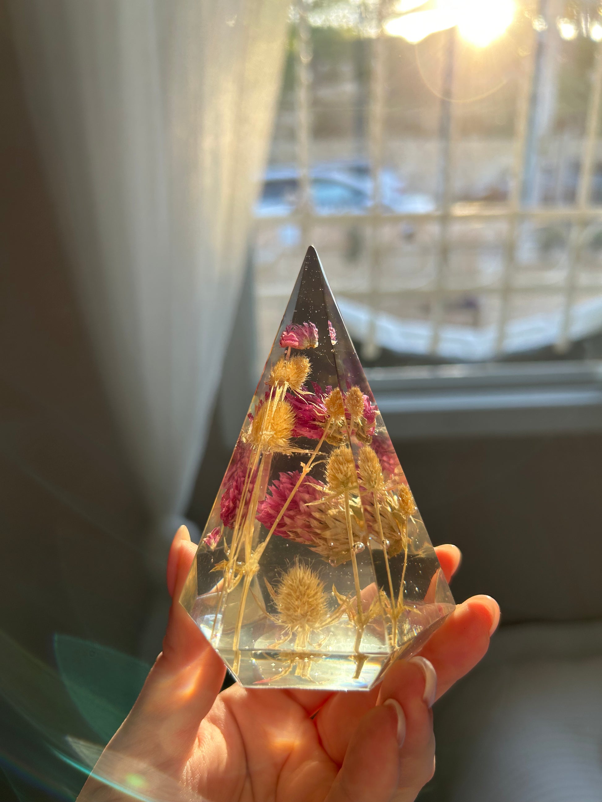 a handmade resin ring tree ring cone featuring floral dried botanicals, a dried desert beige thorn with vibrant fuchsia pink spiky flower. perfect for displaying rings, a unique botanical gift. beautiful, bedroom, bathroom, office, nightstand decor