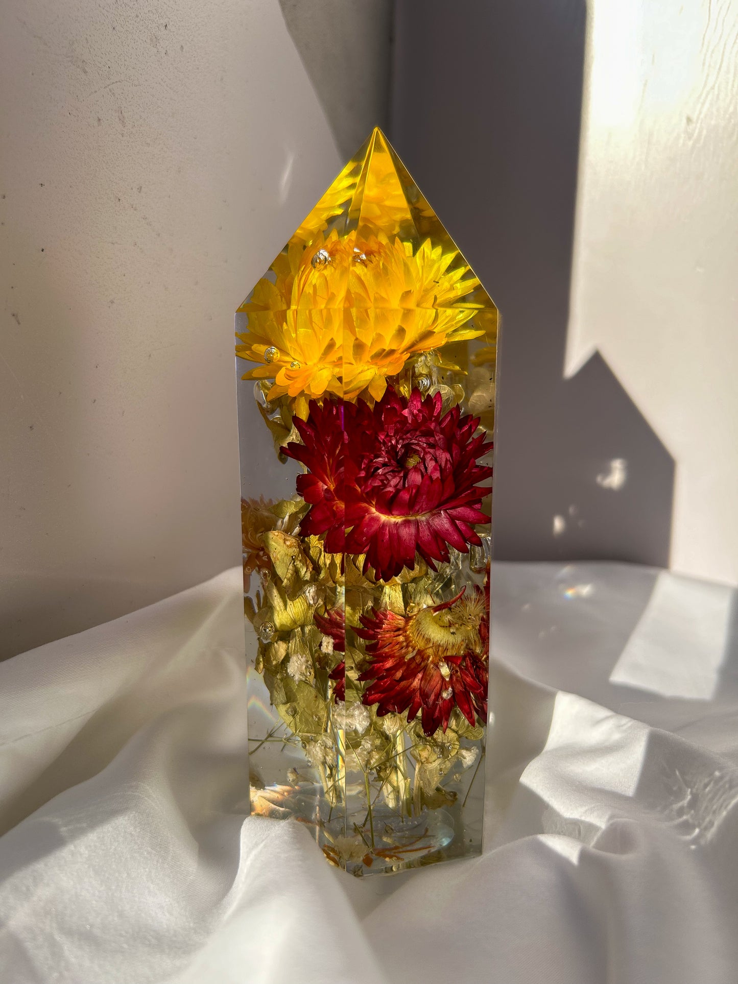 Handmade resin crystal tower featuring a real preserved colorful yellow orange purple pink green flowers, captured in clear resin for a timeless look. Great for home decor, gifts, unique presents, vanity bedroom decor and shelf decor.