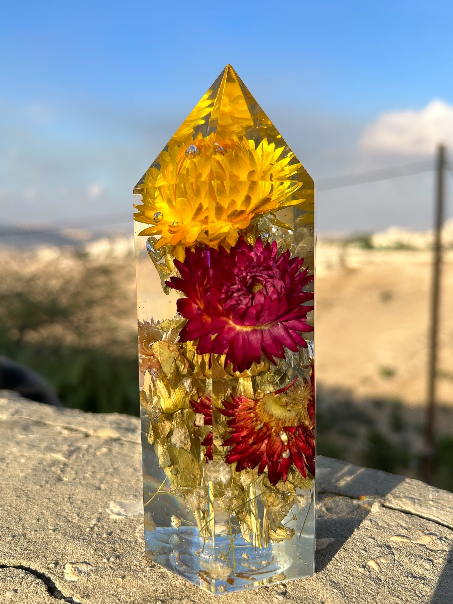 Handmade resin crystal tower featuring a real preserved colorful yellow orange purple pink green flowers, captured in clear resin for a timeless look. Great for home decor, gifts, unique presents, vanity bedroom decor and shelf decor.