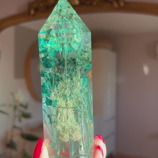 A beautiful handmade epoxy resin crystal made with blue teal, light blue and green natural dried flowers. perfectly cast in crystal clear epoxy resin. Great for home decor, gifts, unique presents, vanity bedroom decor and shelf decor.