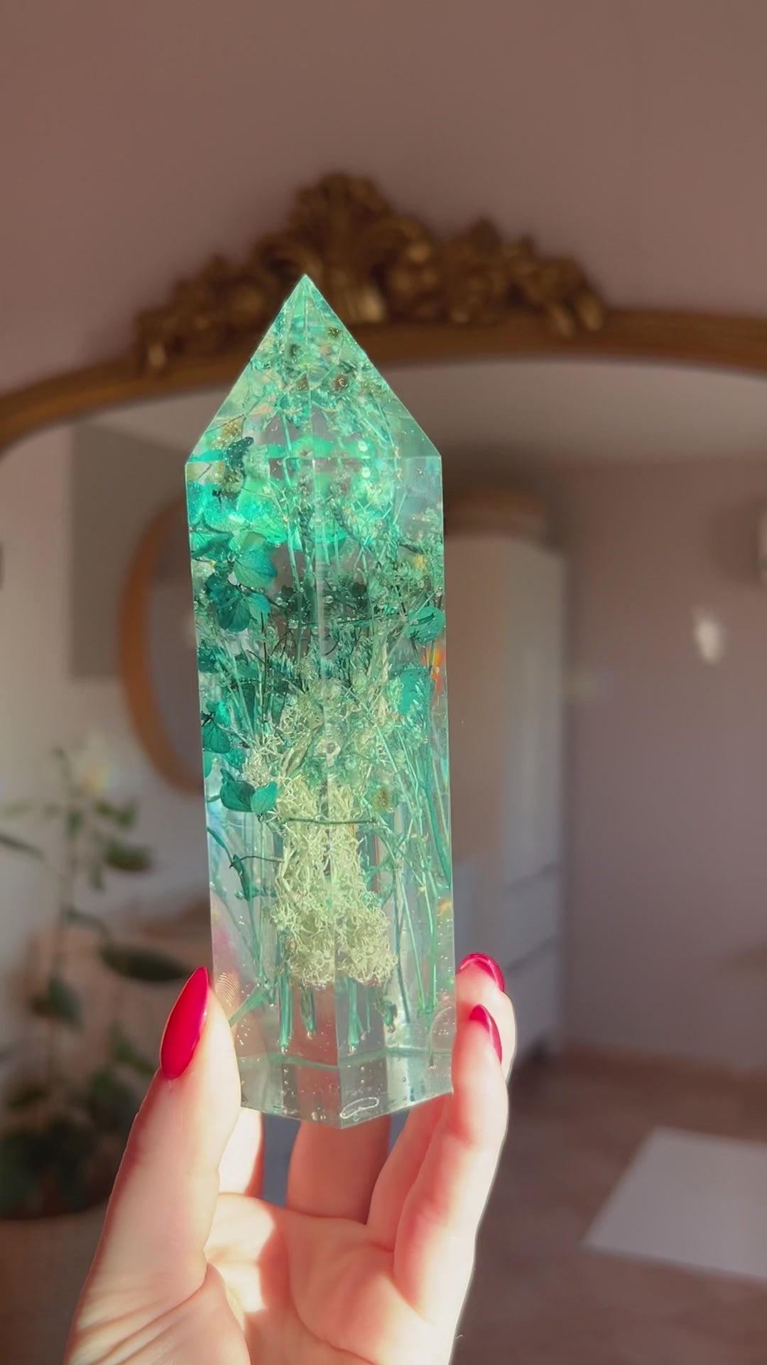 A beautiful handmade epoxy resin crystal made with blue teal, light blue and green natural dried flowers. perfectly cast in crystal clear epoxy resin. Great for home decor, gifts, unique presents, vanity bedroom decor and shelf decor.